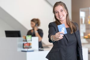 Fletcher employee shows blue Fletcher passport with the word 