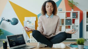 woman meditating in office